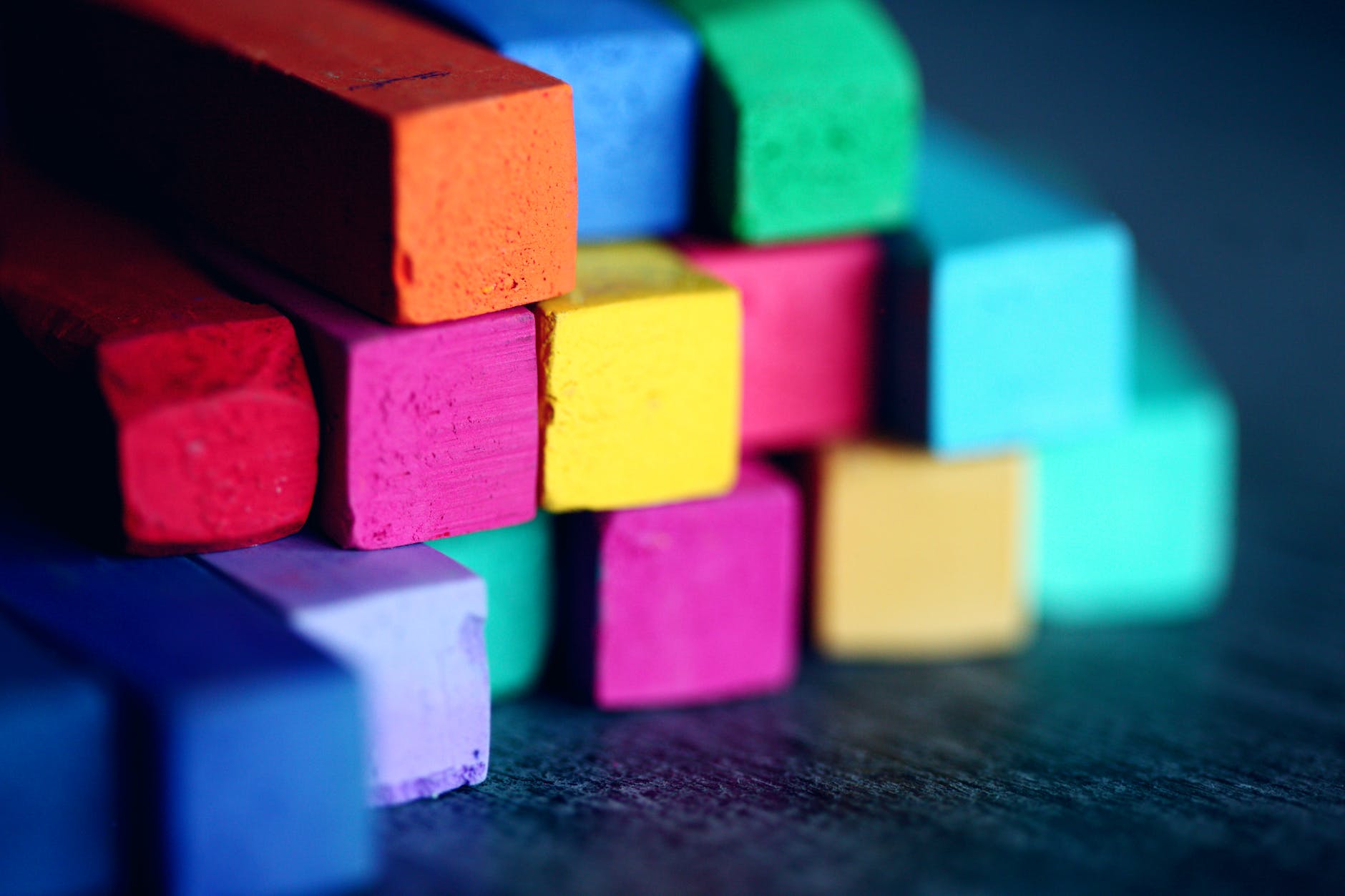 Close-up photo of square-shaped chalks in a variety of rainbow colours.