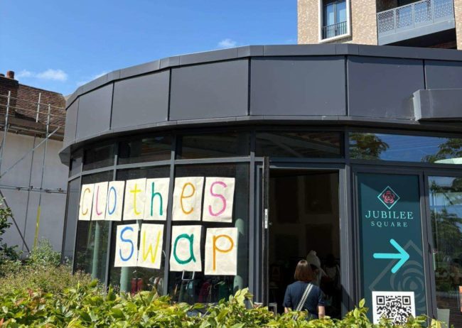 Hand painted sign spelling CLOTHES FEST taken at a St Albans Clothes Swap supporting St Albans Greenpeace