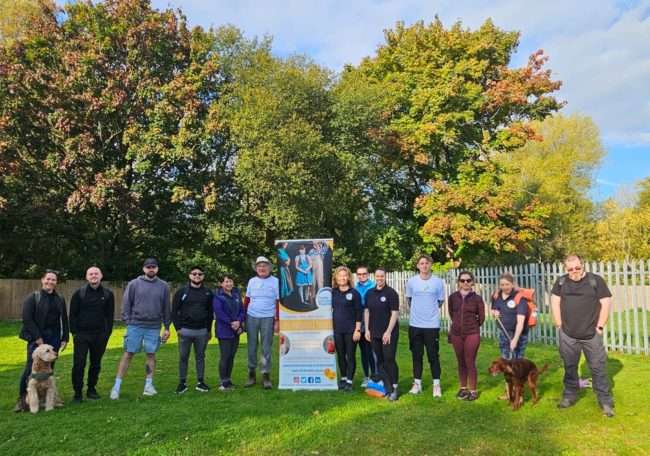 Group of walkers and dogs posting before the Helping Herts 13 mile walk for Herts Inclusive Theatre